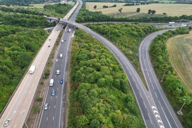 High Angle View of British Motorways at M1 and M25 Interchange. Highways are Passing from Beautiful Landscape with agricultural farms. Aerial View was captured with drone's camera on 7th Sep 2022. 