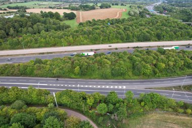 High Angle View of British Motorways at M1 and M25 Interchange. Highways are Passing from Beautiful Landscape with agricultural farms. Aerial View was captured with drone's camera on 7th Sep 2022. 