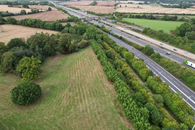 High Angle View of British Motorways at M1 and M25 Interchange. Highways are Passing from Beautiful Landscape with agricultural farms. Aerial View was captured with drone's camera on 7th Sep 2022. 
