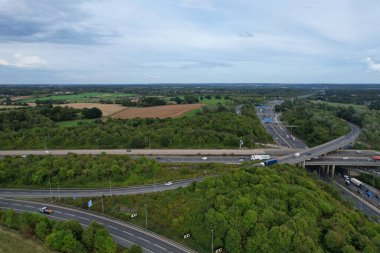 High Angle View of British Motorways at M1 and M25 Interchange. Highways are Passing from Beautiful Landscape with agricultural farms. Aerial View was captured with drone's camera on 7th Sep 2022. 