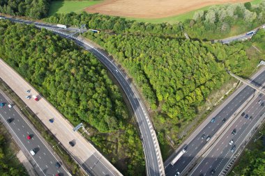 High Angle View of British Motorways at M1 and M25 Interchange. Highways are Passing from Beautiful Landscape with agricultural farms. Aerial View was captured with drone's camera on 7th Sep 2022. 
