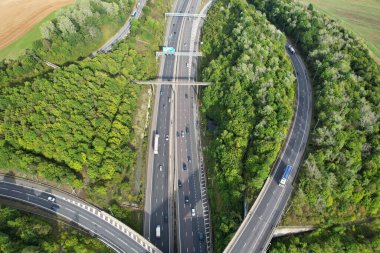 High Angle View of British Motorways at M1 and M25 Interchange. Highways are Passing from Beautiful Landscape with agricultural farms. Aerial View was captured with drone's camera on 7th Sep 2022. 