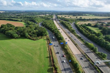 High Angle View of British Motorways at M1 and M25 Interchange. Highways are Passing from Beautiful Landscape with agricultural farms. Aerial View was captured with drone's camera on 7th Sep 2022. 