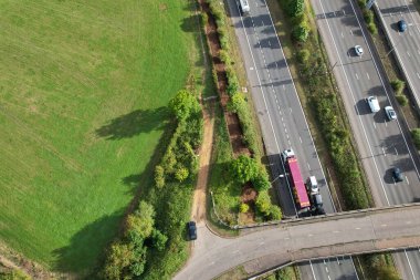 High Angle View of British Motorways at M1 and M25 Interchange. Highways are Passing from Beautiful Landscape with agricultural farms. Aerial View was captured with drone's camera on 7th Sep 2022. 