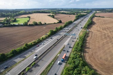 High Angle View of British Motorways at M1 and M25 Interchange. Highways are Passing from Beautiful Landscape with agricultural farms. Aerial View was captured with drone's camera on 7th Sep 2022. 