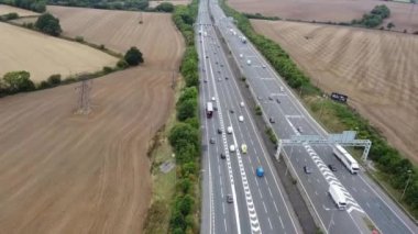Aerial View of British Motorways With Fast Moving Traffic at Peak Time. M1 J11 and  J7 Motorways Junction Interchange. Time Lapse Shot captured on 7th Sep 2022