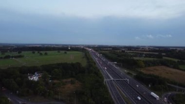 Aerial View of British Motorways With Fast Moving Traffic at Peak Time. M1 J11 and  J7 Motorways Junction Interchange. Time Lapse Shot captured on 7th Sep 2022
