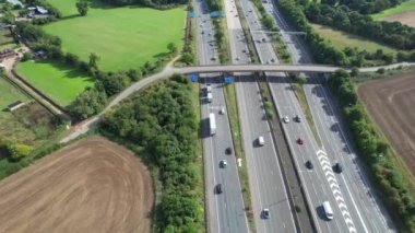 Aerial View of British Motorways With Fast Moving Traffic at Peak Time. M1 J11 and  J7 Motorways Junction Interchange. Time Lapse Shot captured on 7th Sep 2022