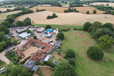 High angle footage and aerial view of harvesting crops at farm view on a sunny day at London Near to St Albans England.