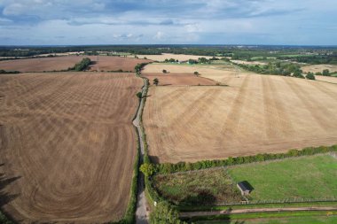 High angle footage and aerial view of harvesting crops at farm view on a sunny day at London Near to St Albans England.