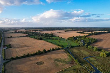 High angle footage and aerial view of harvesting crops at farm view on a sunny day at London Near to St Albans England.