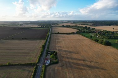 High angle footage and aerial view of harvesting crops at farm view on a sunny day at London Near to St Albans England.