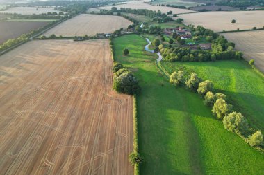 High angle footage and aerial view of harvesting crops at farm view on a sunny day at London Near to St Albans England.
