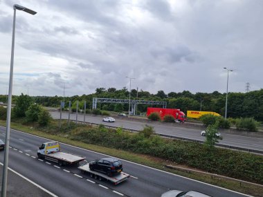 High Angle View of British Road from Bridge of M1 to M25 Interchange at Junction 6 and 7 of Motorways. it also shows the signs of direction to Heathrow and Stanstead Airports. Captured on 7- Sep- 2022