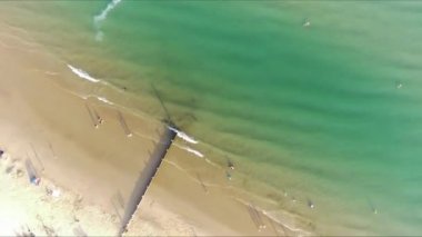 Aerial Footage of people are Relaxing and swimming in the Ocean Water at Beach of Bournemouth England UK