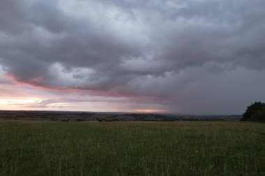 Beautiful and Dramatic Clouds at Sunset Time over British Countryside Landscape