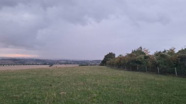 Beautiful and Dramatic Clouds at Sunset Time over British Countryside Landscape