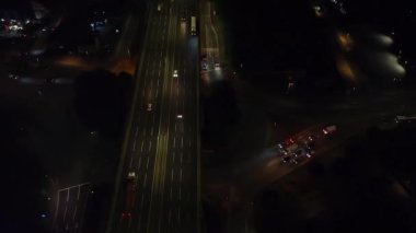 Illuminated Roads and Traffic over British City During Night