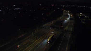 Illuminated Roads and Traffic over British City During Night