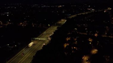 Illuminated Roads and Traffic over British City During Night