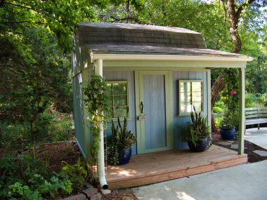 Small light purple shed in Bucyrus Kansas - Surrounded by beautiful plants and flowers