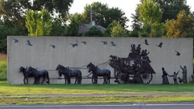 Olathe, Kansas - August, 18 2022 - Old time settlers statue - covered wagon like Oregon Trail video game