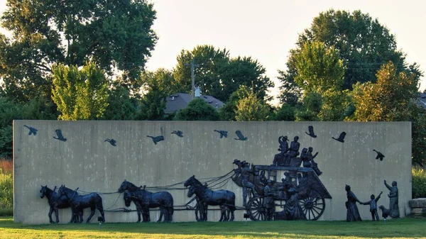 Olathe, Kansas - August, 18 2022 - Old time settlers statue - covered wagon like Oregon Trail video game