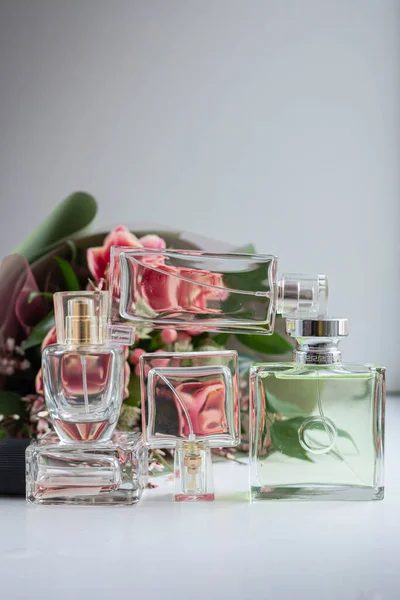 bottle of woman perfume with spring flowers. tulips. gift. present with bouquet