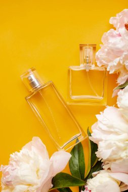 Turuncu masasında şakayık olan parfüm şişeleri