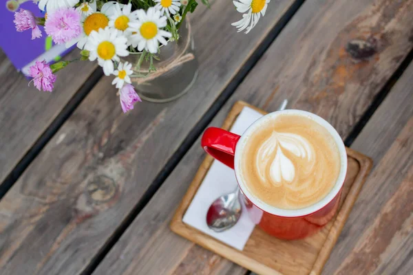 morning coffee with flowers on wooden table