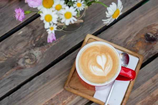 morning coffee with flowers on wooden table