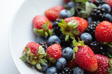seasonal berries in white dish 