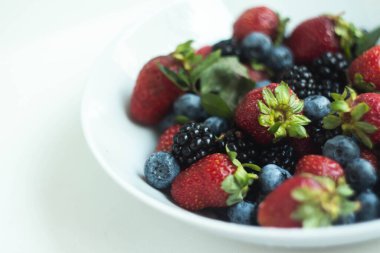 seasonal berries in white dish 