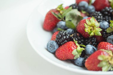 seasonal berries in white dish 