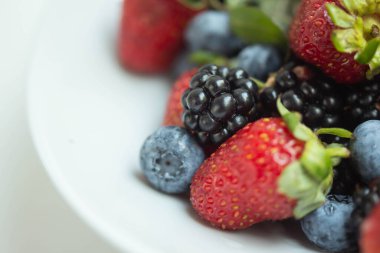 seasonal berries in white dish 