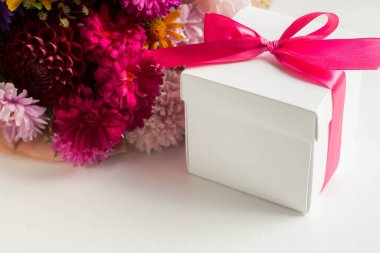 gift box with colorful flowers. asters. autumn bouquet on table
