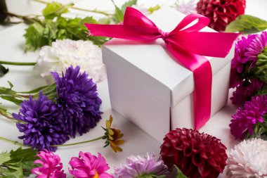 gift box with colorful flowers. asters. autumn bouquet on table