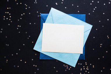 mockup card with stars. invitation card with environment and details Mockup with postcard a on black background.