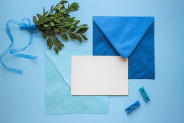 card mockup with leaves and blue envelope. minimalistic