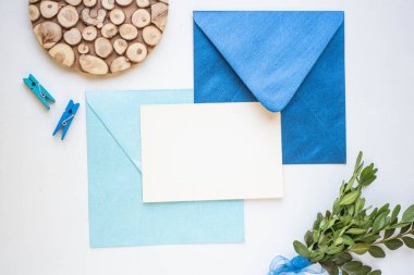 card mockup with leaves and blue envelope. minimalistic