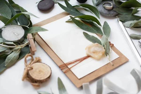 invitation card with leaves, stones and wood