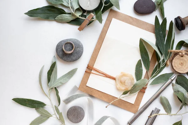 invitation card with leaves, stones and wood