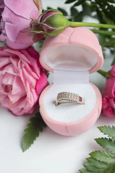 roses and ring in box. proposal golden ring, present to Valentine's day. love present.