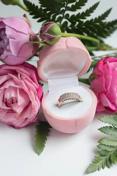 roses and ring in box. proposal golden ring, present to Valentine's day. love present.
