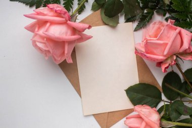 mockup card with roses. invitation card with environment and details Mockup with postcard and flowers on white background.