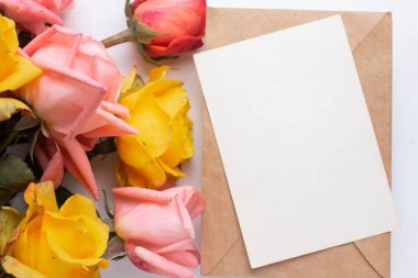 mockup card with roses. invitation card with environment and details Mockup with postcard and flowers on white background.