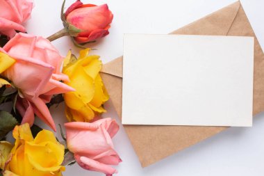 mockup card with roses. invitation card with environment and details Mockup with postcard and flowers on white background.