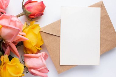 mockup card with roses. invitation card with environment and details Mockup with postcard and flowers on white background.