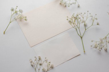 card mockup with white flowers and envelope. wedding invitation 