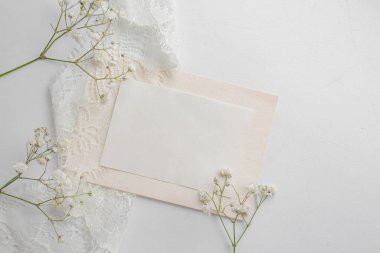 card mockup with white flowers and envelope. wedding invitation 